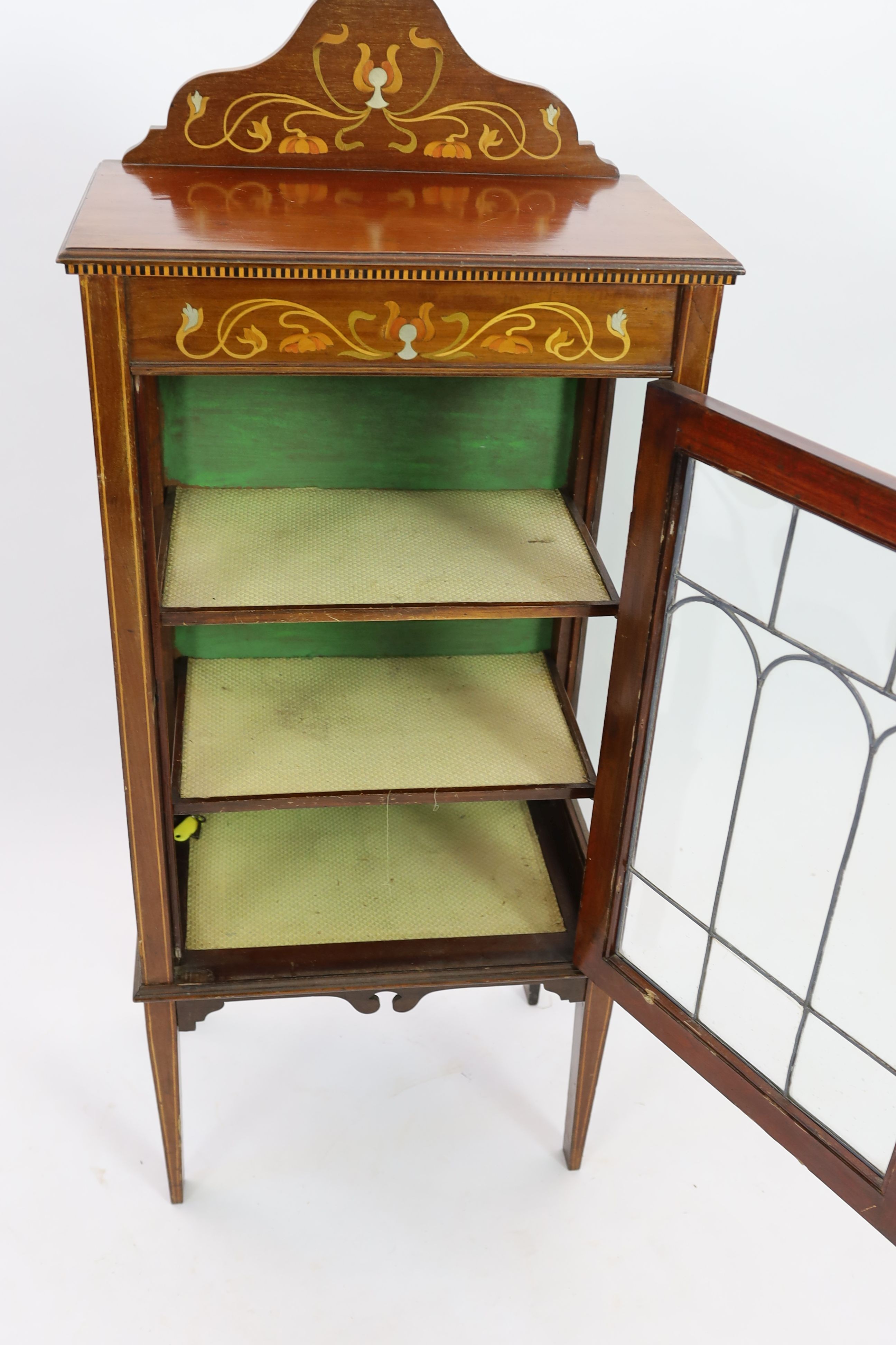 An Edwardian Art Nouveau inlaid mahogany display cabinet, with leaded glazed door, width 56cm depth 35cm height 132cm